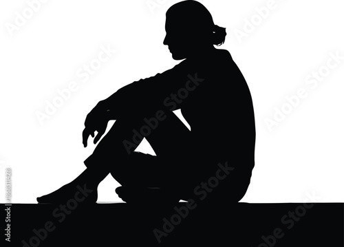 Silhouette of a person sitting alone with head bowed