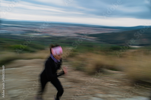 Motion Blur of Woman Running on Hilltop