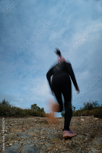 Motion Blur of Person Running on Rocky Path
