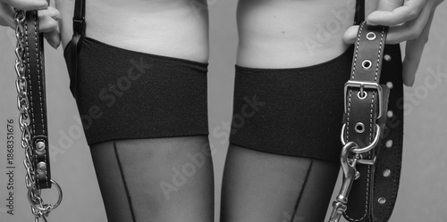 Canvas Print black stockings on women's legs and a collar in her hand