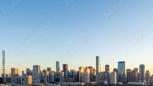 Wallpaper Mural Sunset illuminates modern city skyline with dramatic light transformation Torontodigital.ca