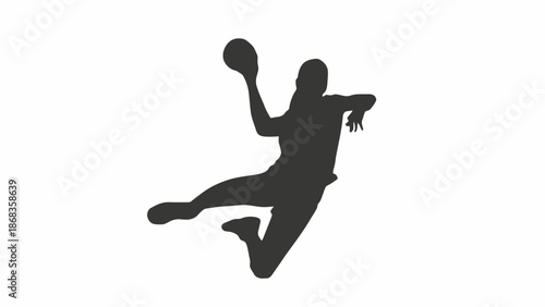 Silhouette of a handball player in mid-air throwing a ball