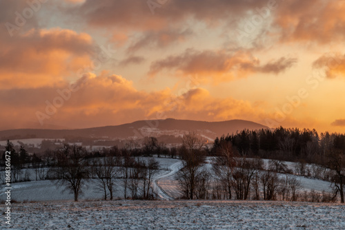 Winter snowy cold sunrise near Roprachtice village in Krkonose mountains