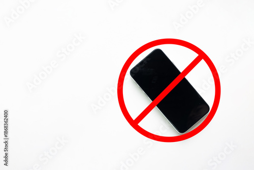 Smartphone with red forbidden sign on white background. Concept of no mobile phone zone, digital detox, technology addiction, banned device, warning rule, and disconnection signal.