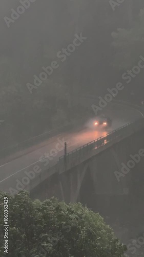 heavy summer storm slows traffic on a bridge