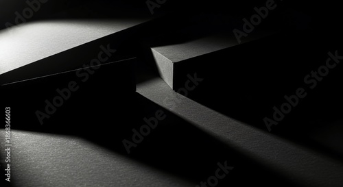 Dramatic interplay of sharp dark shadows and bright light creating fragmented geometric shapes across a textured surface. Minimalist art, projection, visual, modern