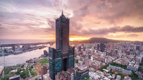 Aerial view of Kaohsiung 85 Sky Tower and Kaohsiung Harbor at sunset, Taiwan cityscape.