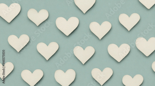 White heart shapes arranged in seamless pattern on soft teal background, creating modern and clean romantic design with subtle textured surface, evoking calm and loving mood