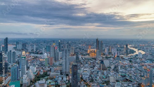 Night timelapse of Chao Phraya River, Bangkok with busy ferries and vibrant city skyline.