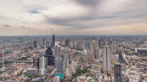 Night timelapse of Chao Phraya River, Bangkok with busy ferries and vibrant city skyline.
