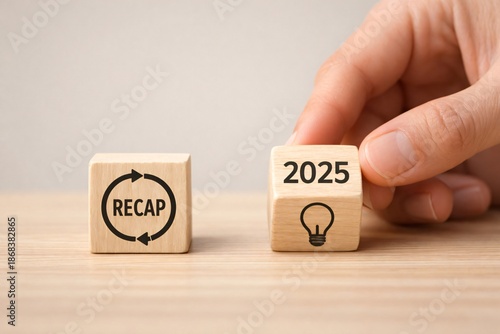 Strategic business recap analysis, hand moving the 2025 innovation lightbulb cube, perfect for economy reports and agreement planning