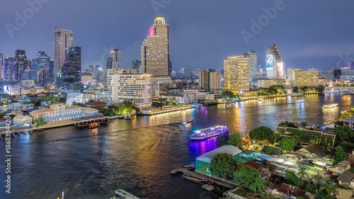 Night Timelapse of Chao Phraya River, Bangkok with Busy Ferries and City Skyline.