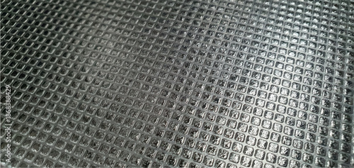 Black metal tile texture. Metal texture made of carbon tile plates on the roof exterior design. Metallic tile texture background. Construction materials. Interior design, decor.