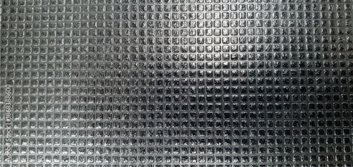 Black metal tile texture. Metal texture made of carbon tile plates on the roof exterior design. Metallic tile texture background. Construction materials. Interior design, decor.