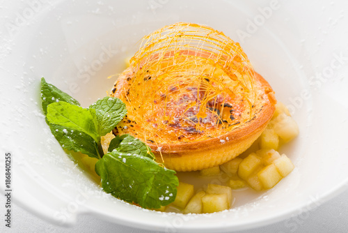 Fotografie Crème brûlée tart with spun sugar and mint