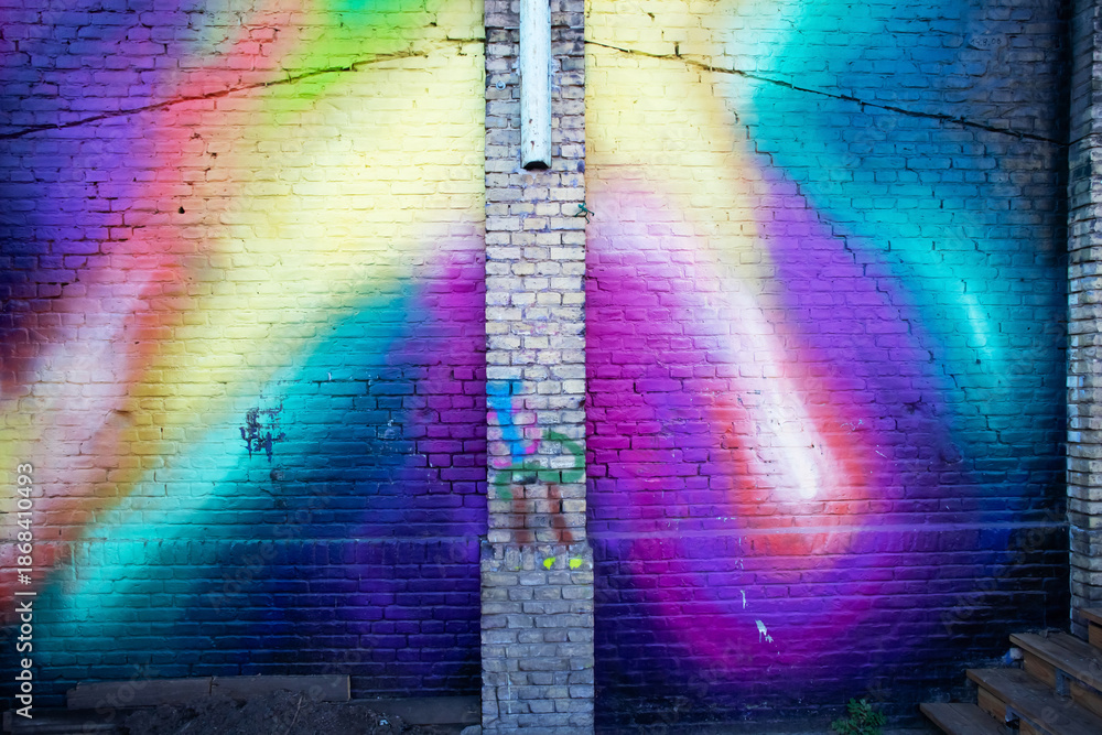 Obraz premium Colourful Rainbow Graffiti Mural on Brick Wall Background