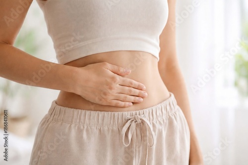 Woman touching her abdomen as a symbol of digestive health, gut wellness, mild stomach discomfort, and healthy lifestyle awareness.