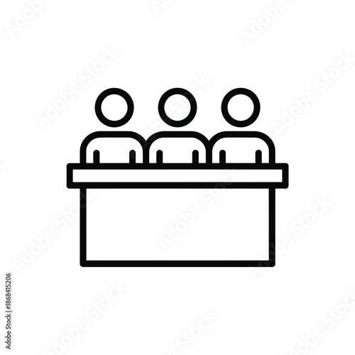 Three people sitting at a table in a meeting or discussion