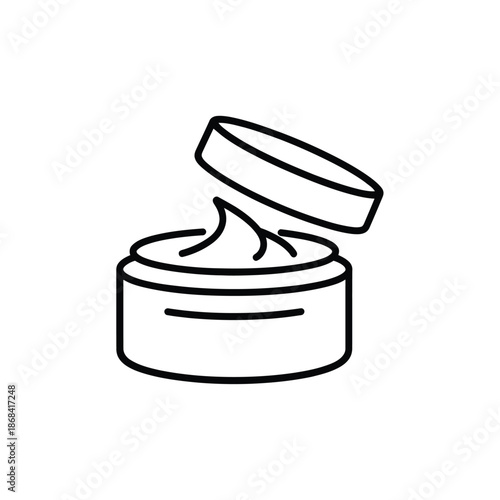 Open jar of cream or moisturizer with lid propped up