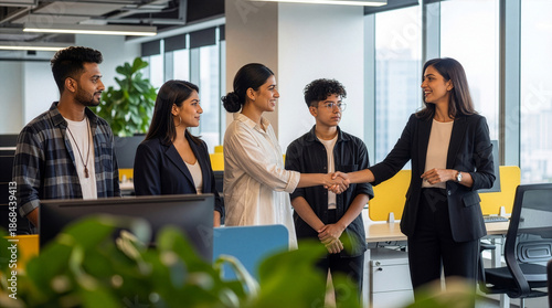 Corporate onboarding and recruitment handshake with diverse team in workspace