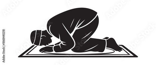 Silhouette of a Muslim man praying in prostration position on a rug for Ramadan and Islamic concepts