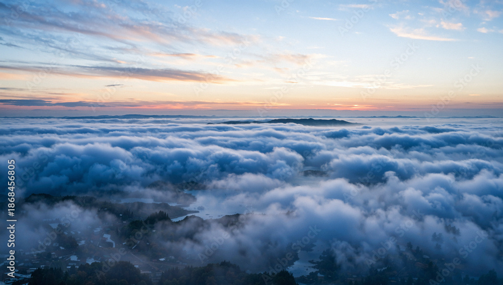 Fototapeta premium Aerial View of Sea of Clouds at Sunrise Over Mountains