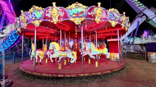 Mysuru, Karnataka, India-October 27 2025; A Merry go round or carousel ride in an amusement part for children and tourists during Dussehra festival carnival in India.
