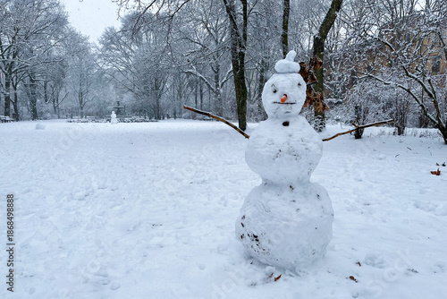 Classic Snowman in Berlin Kreuzberg on a snowy winter day at Grimmstrasse park. 
