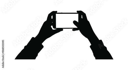 Hands holding a mobile phone capturing a moment in stark contrast silhouette