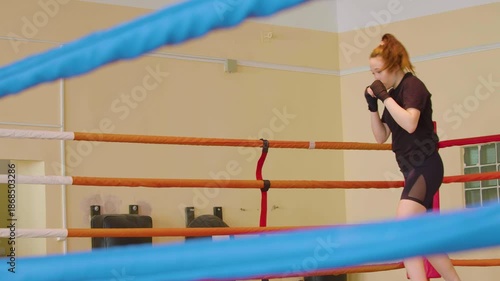 Boxing workout - woman is practicing shadow boxing. Slow motion 4k footage.