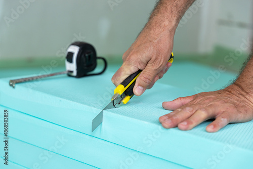 Construction Worker Cutting Insulation Boards