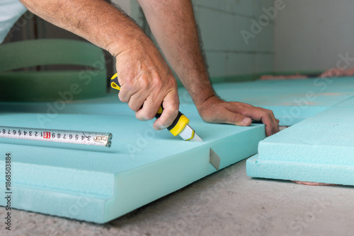 Worker Cutting Out Insulation Board