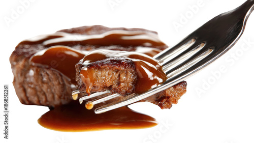 Juicy fried beef steak poured with savory sauce on a fork, gourmet meat close-up on white background for food photography