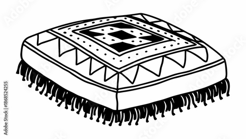 An intricately designed cushion with decorative fringe and geometric patterns is viewed from above on a plain white background.