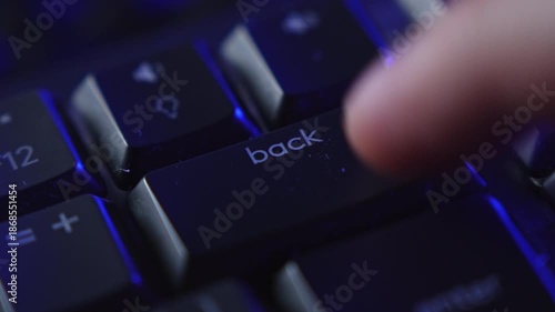 Finger repeatedly pressing backspace key on keyboard