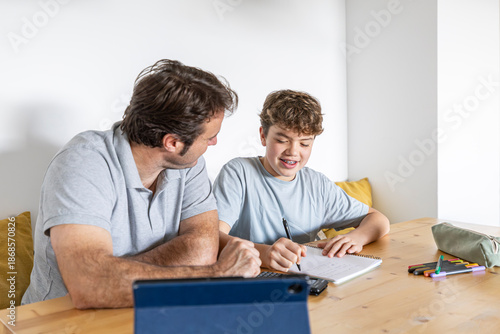 Father helping son with homework education support