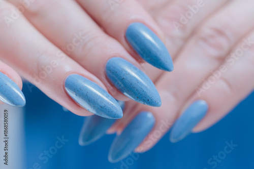 Canvastavla Woman's beautiful hand with long nails and light baby blue manicure