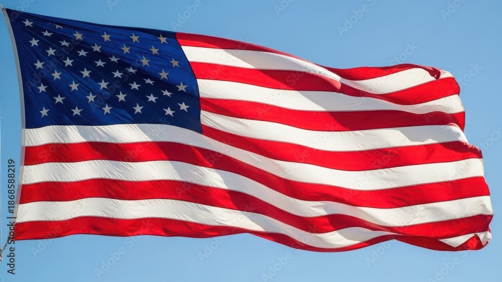 Fototapeta premium American flag waving in the wind against clear blue sky