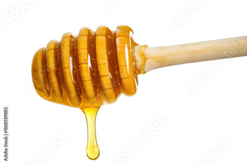 Golden honey dripping from wooden dipper fresh food ingredients natural sweetener closeup isolated on white