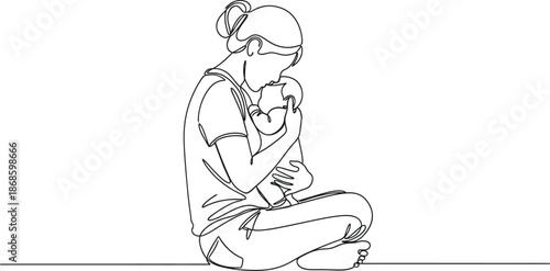 Mother tenderly holding her newborn baby in a peaceful and serene environment