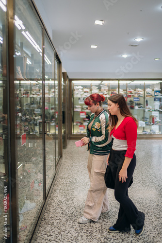 Young women window shopping for shoes together