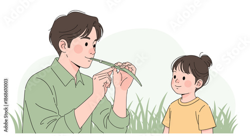 Creative father teaching his curious daughter how to make a simple flute or whistle from a blade of grass while sitting outdoors.