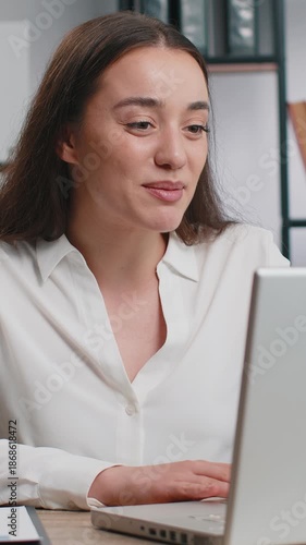 Happy business woman working on laptop computer at home office desk talk on online communication video call with employee, boss. Manager lady freelancer support services looking at webcam of computer