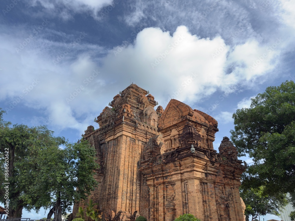 Fototapeta premium Upward View of Cham Temple: Low angle view looking up at the red brick architecture of an ancient Cham temple.