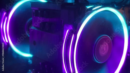 RGB computer cooling fans with neon blue and purple LED rings behind a mesh grille, gaming PC hardware background, futuristic cyberpunk tech mood, abstract pattern, close up.
