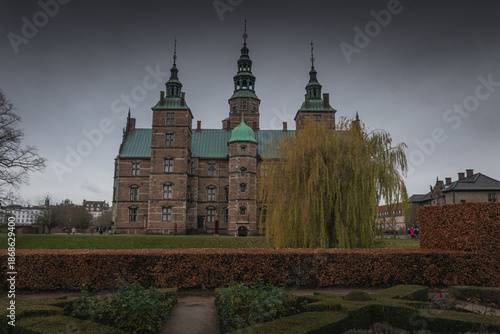 Photography Rosenborg Castle garden view with spires and willow in Copenhagen