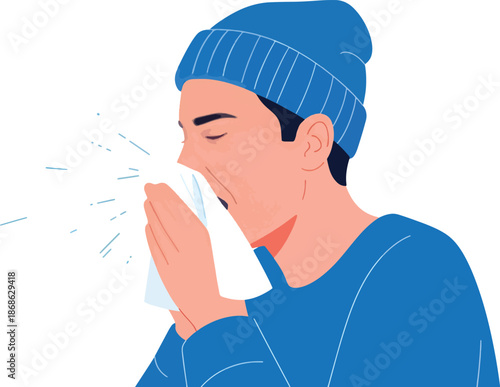 Man in blue beanie sneezing into a white tissue