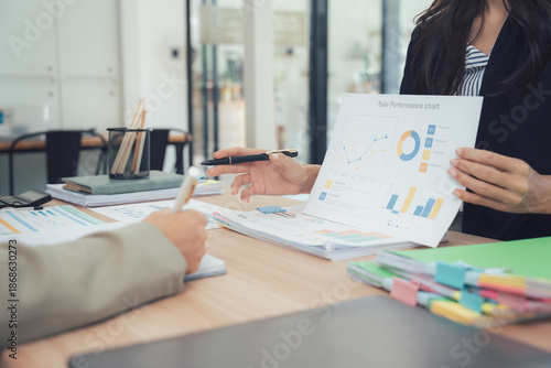 Business Analytics and Analysis: Two business professionals engaged in data analytics, discussing key performance indicators and market insights.