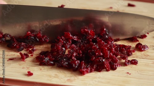 Chopping Dried Cranberries on Wooden Cutting Board