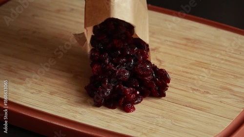 Chopping Dried Cranberries on Wooden Cutting Board
